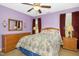 Comfortable bedroom features a ceiling fan, wooden furniture and a large window at 1503 Anterra Dr, Wake Forest, NC 27587