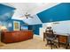 Bonus room with sitting area and office space features blue walls and a ceiling fan at 1503 Anterra Dr, Wake Forest, NC 27587