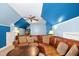 Bonus room with sitting area and desk with interesting blue and light blue colored walls at 1503 Anterra Dr, Wake Forest, NC 27587
