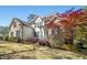 Lovely home exterior featuring brick accents, siding, well-maintained landscaping and a beautiful tree at 1503 Anterra Dr, Wake Forest, NC 27587