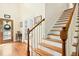 Welcoming foyer with hardwood floors, a staircase, and a decorative front door at 1503 Anterra Dr, Wake Forest, NC 27587