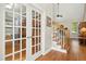 Inviting foyer featuring hardwood floors, staircase with wood railings, and elegant french doors at 1503 Anterra Dr, Wake Forest, NC 27587