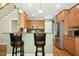 Modern kitchen with stainless steel appliances, breakfast bar, and wood cabinetry at 1503 Anterra Dr, Wake Forest, NC 27587