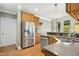 Spacious kitchen with stainless steel refrigerator, modern countertops, and wood flooring at 1503 Anterra Dr, Wake Forest, NC 27587