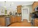 This kitchen features wood flooring, stainless steel appliances, and a breakfast bar perfect for modern living at 1503 Anterra Dr, Wake Forest, NC 27587