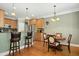 Charming kitchen with breakfast bar, stainless steel appliances, and adjacent dining area at 1503 Anterra Dr, Wake Forest, NC 27587