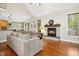 Cozy living room boasts a stone fireplace, hardwood floors, and comfortable seating at 1503 Anterra Dr, Wake Forest, NC 27587