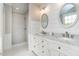 Elegant bathroom featuring double vanities and a glass-enclosed shower at 1545 Heritage Links Dr, Wake Forest, NC 27587