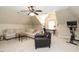 Spacious bonus room with ample seating, a ceiling fan, and exercise equipment at 1545 Heritage Links Dr, Wake Forest, NC 27587