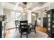 Formal dining room featuring hardwood floors, coffered ceilings, and elegant light fixture at 1545 Heritage Links Dr, Wake Forest, NC 27587