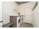 Well-lit laundry room features a side-by-side washer and dryer, shiplap walls, and a folding bench at 1545 Heritage Links Dr, Wake Forest, NC 27587