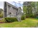 Back exterior with deck, well-maintained lawn, and mature trees, creating a private backyard at 1809 Green Ford Ln, Apex, NC 27502