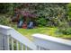 Landscaped backyard featuring Adirondack chairs, a small red table, and well-maintained greenery at 1809 Green Ford Ln, Apex, NC 27502