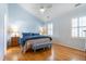 Comfortable bedroom with high ceiling, ceiling fan, hardwood floors, and natural light from the window at 1809 Green Ford Ln, Apex, NC 27502
