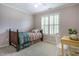 Bedroom with a single bed and desk area, complemented by neutral paint and ample natural light at 1809 Green Ford Ln, Apex, NC 27502