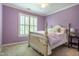 Bedroom with lavender walls, plush carpet, a light ceiling fan, and a window with white shutters at 1809 Green Ford Ln, Apex, NC 27502