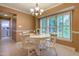 Inviting dining room featuring a modern chandelier, tile floors and natural light from the windows at 1809 Green Ford Ln, Apex, NC 27502