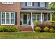 A close-up of the home's entrance, featuring a cozy front porch and manicured landscaping at 1809 Green Ford Ln, Apex, NC 27502
