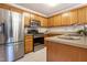 Well-equipped kitchen with stainless steel appliances, oak cabinets, and modern countertops at 1809 Green Ford Ln, Apex, NC 27502