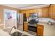 Well-maintained kitchen featuring modern appliances, wooden cabinetry, and updated fixtures at 1809 Green Ford Ln, Apex, NC 27502