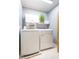 A laundry room with a front loading washer and dryer and tiled floor at 1809 Green Ford Ln, Apex, NC 27502