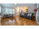 Spacious living room with hardwood floors, comfortable seating, and large windows at 1809 Green Ford Ln, Apex, NC 27502