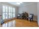 Brightly-lit living room with hardwood floors, neutral walls, and light filtering shutters at 1809 Green Ford Ln, Apex, NC 27502