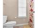 Compact bathroom with a toilet, floral shower curtain, a small window, and neutral wall color at 1919 Sinclair Trce, Burlington, NC 27215