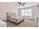 Charming bedroom with a ceiling fan, neutral carpet and a large window with tons of natural light at 1919 Sinclair Trce, Burlington, NC 27215