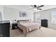 Neutral bedroom with natural lighting, soft carpet, a ceiling fan, and two windows at 1919 Sinclair Trce, Burlington, NC 27215