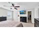 Bright bedroom with a ceiling fan, neutral carpet, a dresser, and a TV at 1919 Sinclair Trce, Burlington, NC 27215