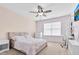 Cozy bedroom featuring neutral carpet, natural light, a ceiling fan, and a white desk and drawers at 1919 Sinclair Trce, Burlington, NC 27215