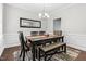 Bright dining room with a modern chandelier, decorative mirror, stylish chairs, and bench seating at 1919 Sinclair Trce, Burlington, NC 27215