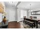Elegant dining room featuring hardwood floors, stylish chandelier, and a large window for natural light at 1919 Sinclair Trce, Burlington, NC 27215