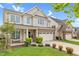 Attractive two-story home with vinyl siding, brick accents, well-kept lawn and a two-car garage at 1919 Sinclair Trce, Burlington, NC 27215