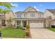 Charming two-story home with a well-manicured lawn, two-car garage, and inviting front porch at 1919 Sinclair Trce, Burlington, NC 27215