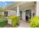 Close up of an inviting front porch with welcoming wreath, colorful plants, and stylish decor at 1919 Sinclair Trce, Burlington, NC 27215