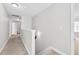 Upstairs hallway with neutral walls and carpet at 1919 Sinclair Trce, Burlington, NC 27215