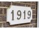 Close-up of house number '1919' on brick exterior, adding a classic touch to the property at 1919 Sinclair Trce, Burlington, NC 27215