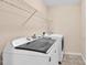 Well-equipped laundry room with a modern washer and dryer, and a wire rack above the units at 1919 Sinclair Trce, Burlington, NC 27215