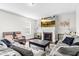 Cozy living room featuring a fireplace, comfortable seating, and a mounted TV for relaxed living at 1919 Sinclair Trce, Burlington, NC 27215