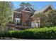 Two-story brick home with a front yard surrounded by greenery at 208 E Jules Verne Way, Cary, NC 27511
