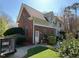 Rear exterior elevation of a home showcasing brickwork and access to the backyard at 208 E Jules Verne Way, Cary, NC 27511