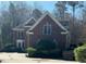 Charming two-story brick home featuring mature landscaping and a well-maintained front yard at 208 E Jules Verne Way, Cary, NC 27511