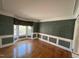 Elegant living room featuring large windows, hardwood floors, and architectural details at 208 E Jules Verne Way, Cary, NC 27511