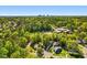 Aerial view showing homes nestled among lush trees and a skyline in the distance at 209 Dickens Dr, Raleigh, NC 27610