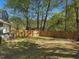 Spacious backyard featuring a well-maintained lawn and a secure wooden fence for privacy at 209 Dickens Dr, Raleigh, NC 27610