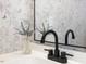 Bathroom sink featuring a matte black faucet and floral wallpaper at 209 Dickens Dr, Raleigh, NC 27610