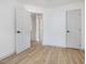 Bright bedroom with hardwood floors and multiple doors at 209 Dickens Dr, Raleigh, NC 27610