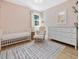 Charming Bedroom showcasing a crib, rocking chair, patterned rug, and stylish décor at 209 Dickens Dr, Raleigh, NC 27610
